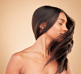 Image showing Hair care, beauty and woman shake head in studio isolated on a brown background. Hairstyle, natural cosmetics and model in salon treatment for texture growth, balayage and aesthetic for wellness.
