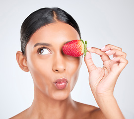 Image showing Kiss face, strawberry and woman with beauty, nutrition and health with shine isolated on white background. Fruit, vegan and wellness with eco friendly skincare, natural cosmetics and pout in studio