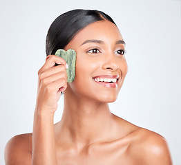 Image showing Woman, skin and gua sha, natural beauty and tools with jade stone for skincare and face on white background. Facial massage, facelift and grooming with glow, dermatology and wellness in studio