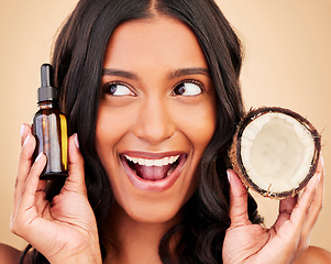 Image showing Happy woman, hair and beauty, coconut oil product with natural treatment and cosmetic care on studio background. Haircare, eco friendly and vegan with fruit, serum and shampoo with bottle and shine