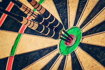 Image showing Three darts in bull's eye close up