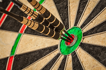 Image showing Three darts in bull's eye close up