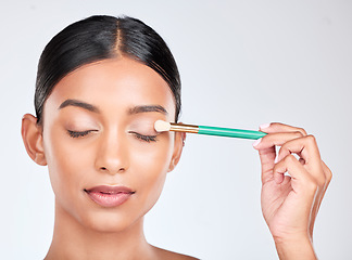 Image showing Face, eyeshadow and brush, woman and makeup with beauty product and tools isolated on white background. Lashes, apply powder with cosmetics and skin with shine, glow and wellness in a studio