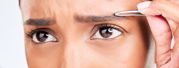 Image showing Eyes, pain and woman with tweezers for eyebrow in studio, tools for self care and grooming. Facial hair removal, dermatology and beauty skincare, face of model on white background for clean skin glow