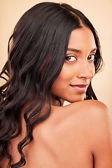 Image showing Hair care, beauty and face of woman in studio isolated on a brown background. Curly hairstyle, natural cosmetics and portrait of Indian model in salon treatment for growth, health and skin wellness