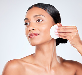 Image showing Face, woman and cotton pad, beauty and makeup removal with skincare and clean facial isolated on white background. Hygiene, cosmetics and product with wellness, dermatology and skin shine in a studio