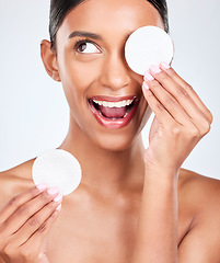 Image showing Face, happy woman and cotton pad, beauty and makeup removal with skincare and clean on white background. Hygiene, excited for cosmetics and product with wellness, dermatology and skin shine in studio