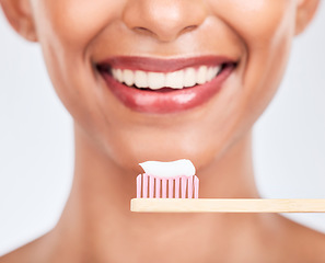 Image showing Toothbrush, toothpaste and dental with woman and closeup, health and fresh breath isolated on white background. Bamboo, mouth and teeth whitening with oral care, orthodontics and routine in studio