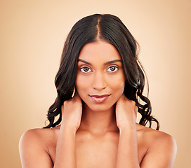 Image showing Curly hair, beauty and face of woman in studio isolated on a brown background. Hairstyle care, natural cosmetics and portrait of Indian model in salon treatment for health, wellness or skin aesthetic