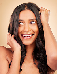 Image showing Hair care, beauty and young woman in studio for shiny, long and clean hairstyle with salon treatment. Wellness, health and female model with cosmetic routine for hair maintenance by brown background.