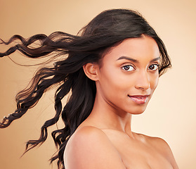 Image showing Hair, wind and beauty with woman in portrait, keratin treatment and smile isolated on studio background. Shine, salon hairstyle and haircare with texture, growth and cosmetic care with curls