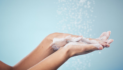 Image showing Cleaning, hands and woman with soap and water in studio, blue background and healthcare or skincare mockup. Model, closeup or washing skin for clean, hygiene and protection from bacteria or virus