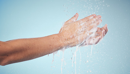 Image showing Hands, cleaning and woman with soap and water in studio, blue background and healthcare mockup or skincare. Model, closeup or washing skin for clean, hygiene and protection from bacteria or virus