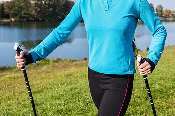 Image showing Closeup of woman's hand with nordic walking poles