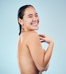 Image showing Shower, portrait or happy woman cleaning body for wellness or dermatology in studio on blue background. Smile, beauty or wet girl washing or grooming for healthy natural hygiene or skincare to relax