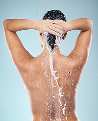 Image showing Hair care, shampoo or woman washing in shower for wellness or healthy head on blue background. Cosmetics, beauty model or back of wet person washing or grooming for natural hygiene to relax in studio
