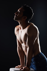 Image showing Topless, sexy and man in dark studio for fitness inspiration, beauty aesthetic or casual fashion. Strong body and shirtless male model with muscle, black background and healthy art with lighting