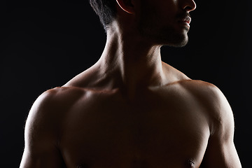Image showing Topless, muscle and sexy man in black background for fitness inspiration, beauty aesthetic or healthy body. Shadow, torso of strong male model or bodybuilder in dark studio with art lighting for gym.