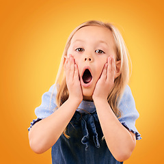 Image showing Wow, surprise and hands on face of girl child in studio with news, announcement or giveaway on orange background. Omg, portrait and kid shocked by secret, gossip or drama, promotion or information