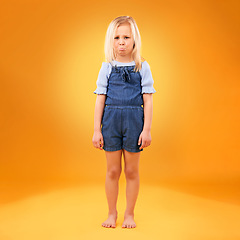 Image showing Portrait, sad and girl child in studio with bad news, feedback or negative review on orange background. Face, frown and kid with emoji disappointed expression, angry or tantrum, reaction or behavior