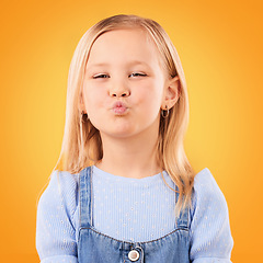 Image showing Happy, pout and portrait of girl on orange background with happiness, joy and excited in studio. Confidence, childhood and face of young, adorable and cute child with kiss emoji facial expression