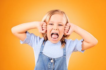 Image showing Portrait, girl and kid with anger, screaming or emoji with emotion on a yellow studio background. Face, person or model with stress, frustrated or shouting with a child, facial expression or attitude