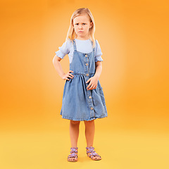 Image showing Angry, sad and portrait of girl child in studio with bad news, feedback or negative, review or vote on orange background. Face, frown and annoyed kid with emoji tantrum, behavior or attitude problem