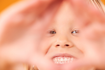 Image showing Girl child, triangle hands and studio portrait with smile, excited and sign language by yellow background. Female kid, pyramid icon and face with frame, happy and closeup for diamond, symbol or emoji