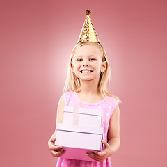 Image showing Gift, birthday party and portrait of child with a hat for holiday or happy celebration. Excited girl on a pink background for surprise, giveaway prize or celebrate win at event with a present and joy