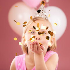 Image showing Balloons, birthday and girl with confetti on pink background for party, celebration and special day. Happy, excited and young child with decoration for magic, wonder and glitter for event in studio