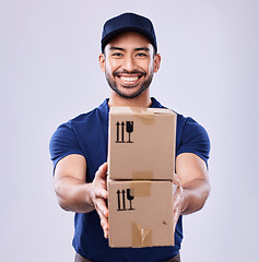 Image showing Smile, portrait and delivery man with boxes in studio, safe transport for ecommerce supplier product. Package, logistics and happy courier person on white background for online sales and services.