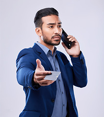 Image showing Credit card, phone call and a business man in studio for communication or fintech payment. Asian person, smartphone and finance for membership subscription, account or banking info on grey background