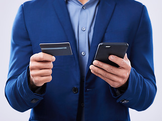 Image showing Closeup, hands and a person with a phone and credit card on a studio background for ecommerce. Website, digital or an online customer doing shopping, banking or payment on an easy mobile app