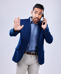 Image showing Business, phone call and man with hand, stop or wait in studio for listen, attention or ask on grey background. Emoji, palm and Asian male person with smartphone conversation and icon for rejection