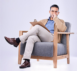 Image showing Portrait, serious and a man psychologist in a chair on a white background in studio to listen for diagnosis. Psychology, mental health and concern with a person counseling during a therapy session
