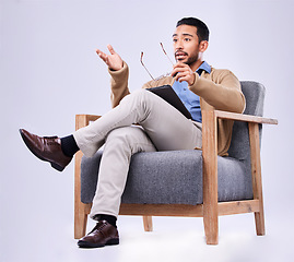 Image showing Tablet, explain and a man psychologist in a chair on a white background in studio to listen for diagnosis. Psychology, mental health and information with a person counseling during a therapy session