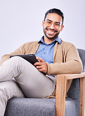 Image showing Portrait, tablet and psychology with a man in a chair on a white background in studio to listen for diagnosis. Psychologist, mental health and smile with a happy person counseling during therapy