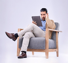 Image showing Tablet, concern and a man psychologist in a chair on a white background in studio to listen for diagnosis. Psychology, mental health and reading information with a person counseling during therapy