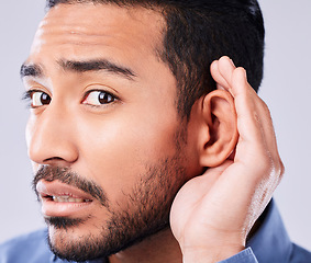 Image showing Whisper, portrait and hand on ear of man in studio with speak up, listen or announcement on grey background. Gossip, face and Asian guy model with emoji for what, pardon or curious, listening or news