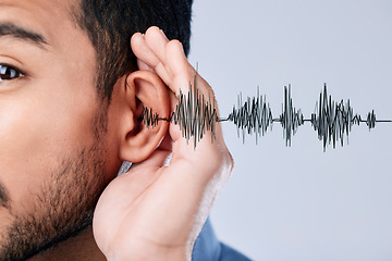 Image showing Ear, listening and sound waves with a hand on a studio background for communication, gossip or attention. Closeup, digital and a person for hearing an audio, speaker or frequency for conversation