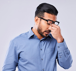 Image showing Tired, crisis and man with a headache on a studio background for mental health or burnout. Anxiety, sick or an Asian businessman with migraine pain from depression, mistake or frustrated with a fail