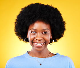 Image showing Portrait, smile and young black woman in studio with afro, good mood and cool personality on yellow background. Face of happy, confident and modern African model with pride, curly natural hair or joy