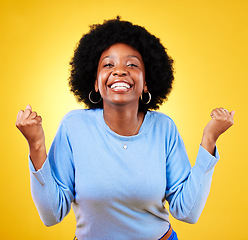 Image showing Woman, portrait and fist in studio of success, celebrate promotion or winning lottery bonus on yellow background. Happy african model, cheers or celebration of achievement, deal or lotto prize winner