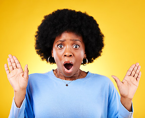 Image showing Scared, surprise and a shocked woman in studio for fear, mental health or surrender. Portrait of African person on yellow background mouth open, hands up or frightened by phobia, gossip or horror