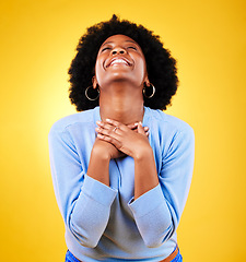 Image showing Happy, excited and a young woman in studio with good news, hope and gratitude. Black person or winner on a yellow background for announcement, hands on chest and grateful for luck or self love