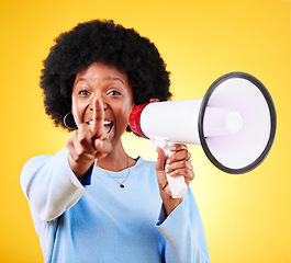 Image showing Pointing, happy woman and loudspeaker or megaphone in studio for voice or announcement. African person portrait with speaker for broadcast message, breaking news or speech on yellow background