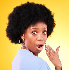 Image showing Portrait, hand and face of surprised black woman in studio, shocked and wow emoji for gossip, drama or news. Person, omg and girl with afro hearing announcement and is mind blown on yellow background