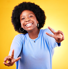 Image showing Hand sign, peace and portrait of a woman in studio with fun emoji, excited face and v symbol. Happy african person on yellow background for positive mood, motivation and review with gesture or vote