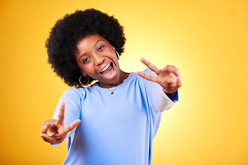 Image showing Peace, hand sign and portrait of a woman in studio with fun emoji, excited face and v symbol. Happy african person on yellow background for positive mood, motivation and review with gesture or vote