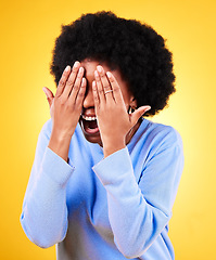 Image showing Hands, wow and laughing with an afro black woman on a yellow background in studio for surprise. Smile, bonus and excited with the reaction of a happy young person to good news or a funny joke